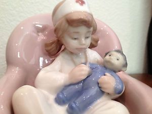 Lladro Nao Girl Nurse with Doll on Pink Chair